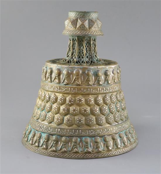 A 13th century Khorassan silver and copper inlaid bronze candlestick, 10.5in.